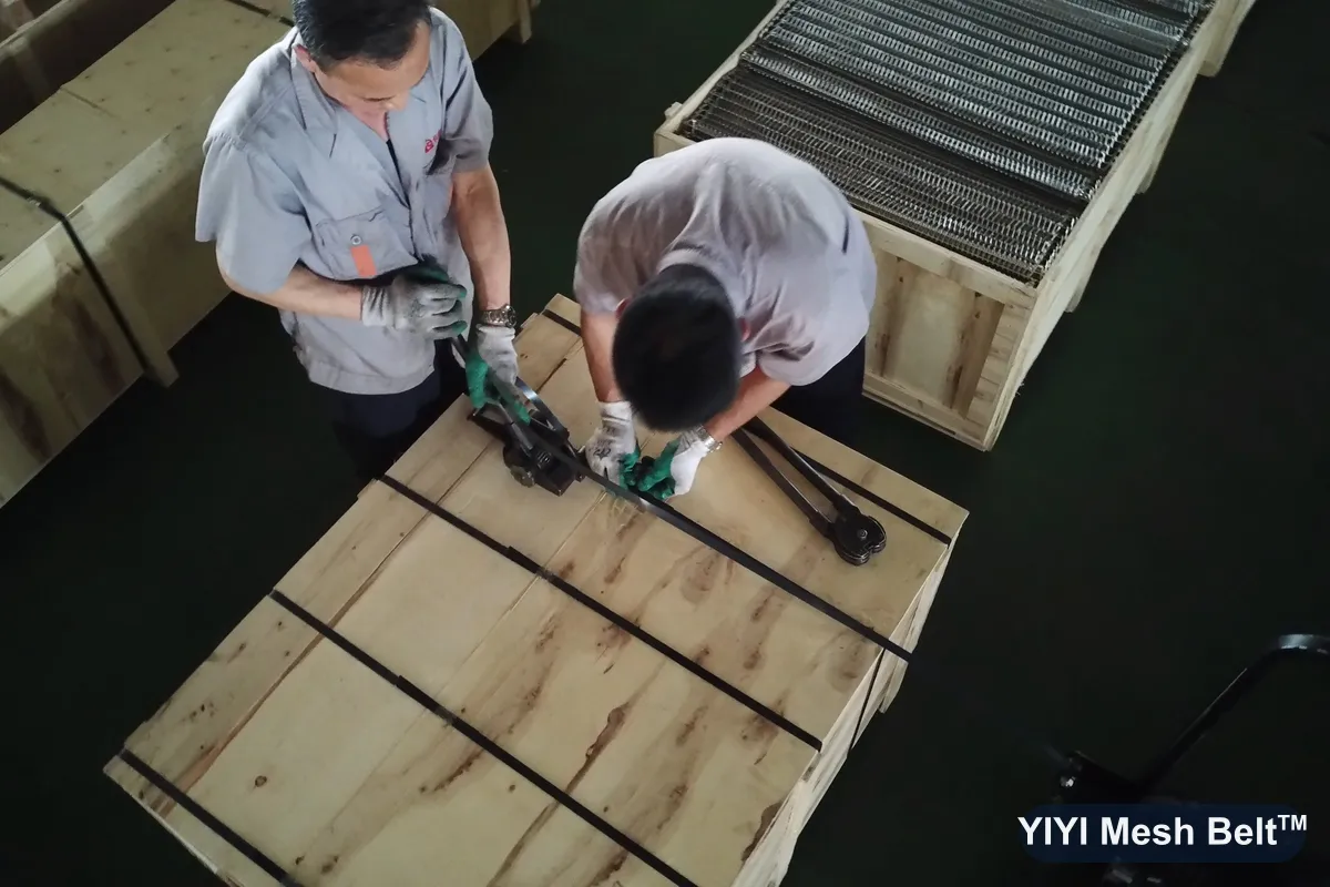 Workers closing and strapping export wooden cases