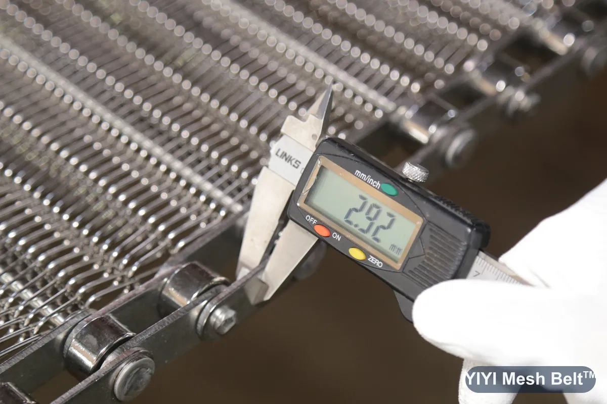 Caliper measuring a finished belt during inspection