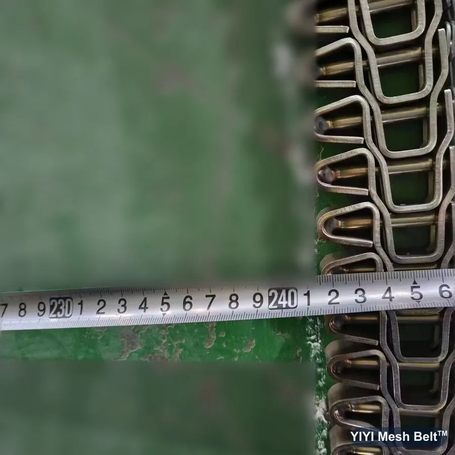 Side driven spiral belt section laid out for a turning check