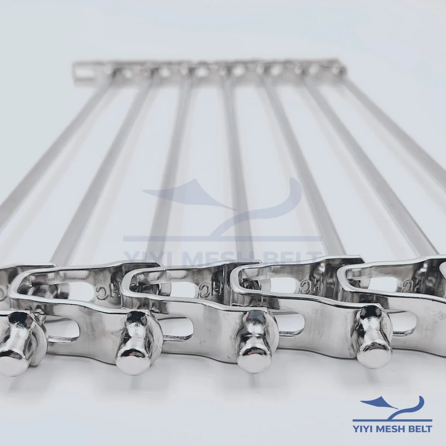 Button cap welded edge on a spiral freezer belt chain