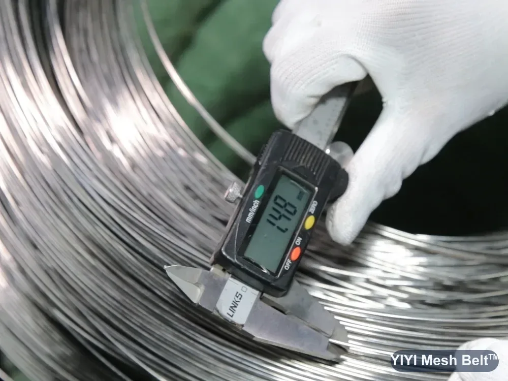 Caliper checking the diameter of a stainless steel wire coil