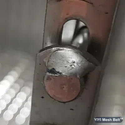 Rod-end weld standing proud of the link on a spiral belt edge