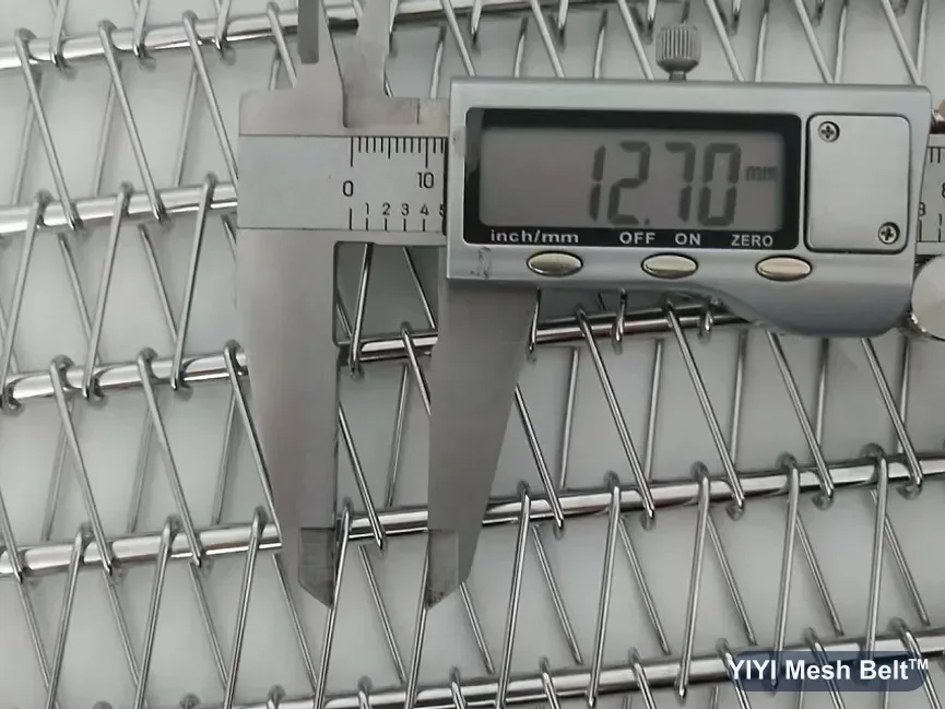 Digital caliper measuring the link of a spiral freezer belt trial section